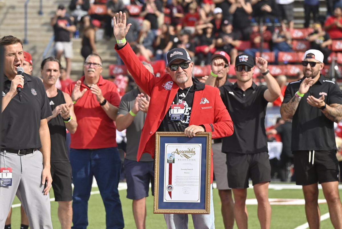 Former Fresno State head football coach Jeff Tedford waves to the audience during halftime of the game against San Diego State Saturday, Oct. 24, 2025 in Fresno. 