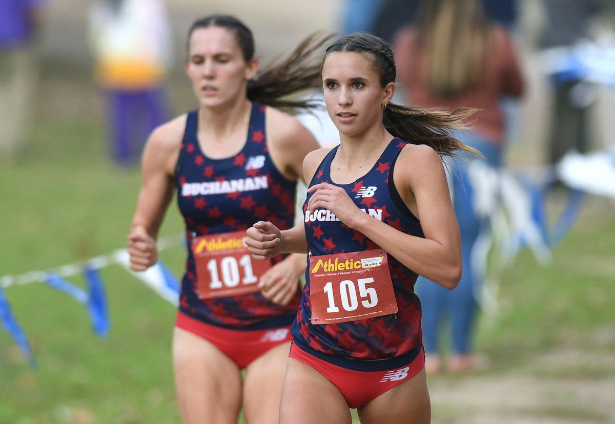 Buchanan’s Sydney Sundgren, right, leads teammate Grace Hutchison, left, and the rest of the field to a one-two finish at the Central Section cross country DI Girls chamionship held at Woodward Park Thursday, Nov. 18, 2021 in Fresno.