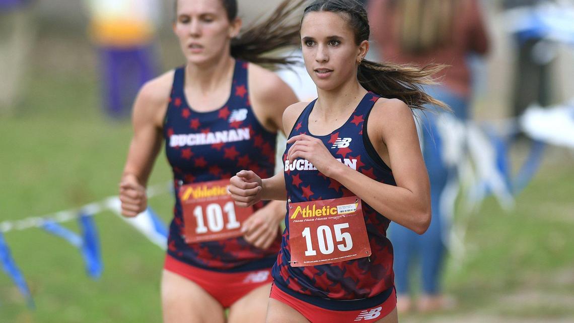 Buchanan’s Sydney Sundgren, right, leads teammate Grace Hutchison, left, and the rest of the field to a one-two finish at the Central Section cross country DI Girls chamionship held at Woodward Park Thursday, Nov. 18, 2021 in Fresno.
