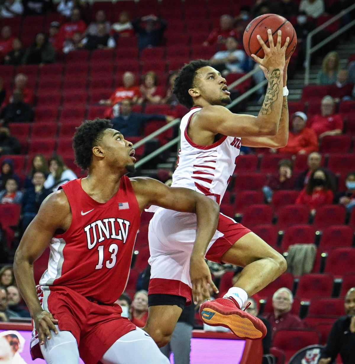 Fresno State’s Isaiah Hill, right, drives to the hoop while defended by UNLV’s Bryce Hamilton during their game at the Save Mart Center in Fresno on Wednesday, Feb. 16, 2022.