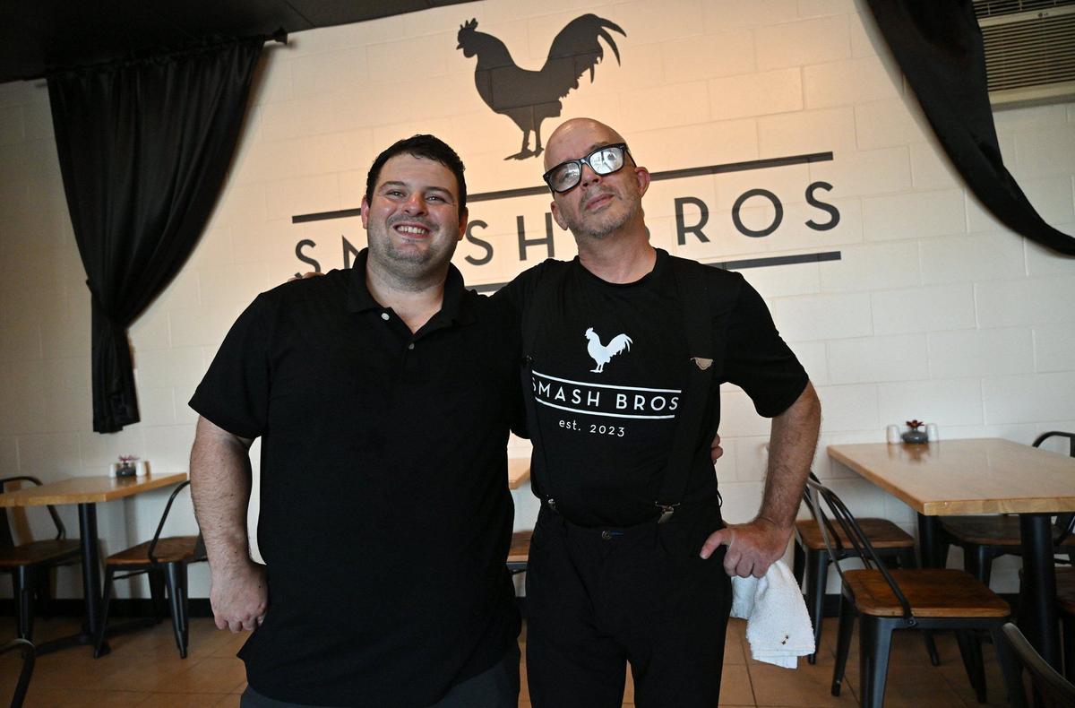 Chefs Jonathan Aviles, left, and Matthew Simons, right, have opened Smash Bros Bistro at Fresno Street and Bullard Avenue, serving up food beyond simply smashburgers.