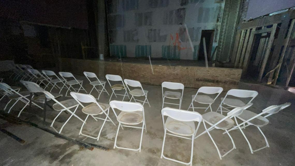 Two rows of plastic chairs face the stage inside the gutted interior of Hardy’s Theater in downtown Fresno, as seen during a building inspection by city officials on April 28, 2023.