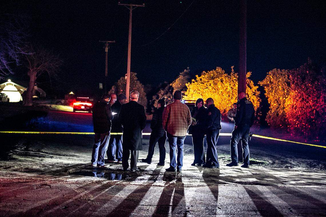 Detectives investigate a crime scene after a suspect stabbed a K-9 and was shot by police along a dirt road near American and Maple avenues in Fresno County on Sunday, Jan. 2, 2022,