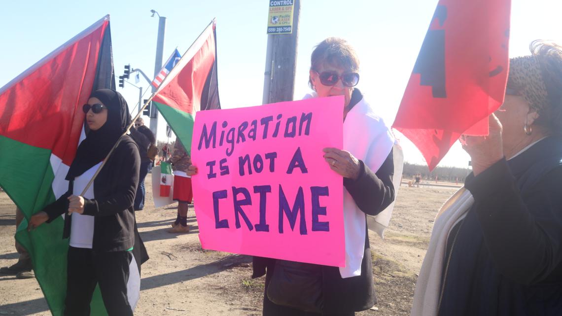 A couple of dozen people holding banners that read ‘Migration is not a crime” showed up to support immigrant farmworkers at the corner of South Laspina Street and East Paige Avenue as Ag show attendees drove by to the annual World Ag Expo on Tuesday, Feb. 11, 2025.