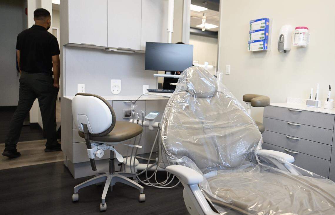 Visitors on tour pass an exam room at the grand opening for United Health Centers' new Cesar Chavez Health Center in west Fresno on Friday morning, Oct. 23, 2025 in Fresno.