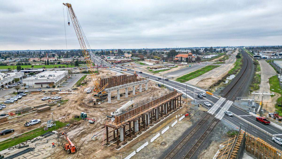 Traffic diverts around a detour at Shaw Avenue and Golden State in Fresno as construction on the California High-Speed Rail overpass gets underway on Monday, Dec. 29, 2025.
