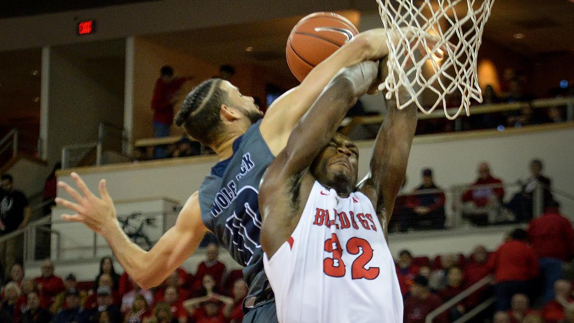 Fresno State forward Nate Grimes, right, gets fouled by Nevada’s Caleb Martin while going for a fast-break dunk during the Bulldogs’ 74-64 loss to the Wolf Pack at the Save Mart Center on Saturday, Jan. 12, 2019.