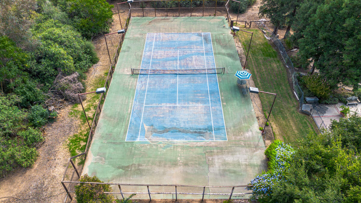 A tennis court is included at the 107-year-old Balfe Ranch House for sale east of Clovis.
