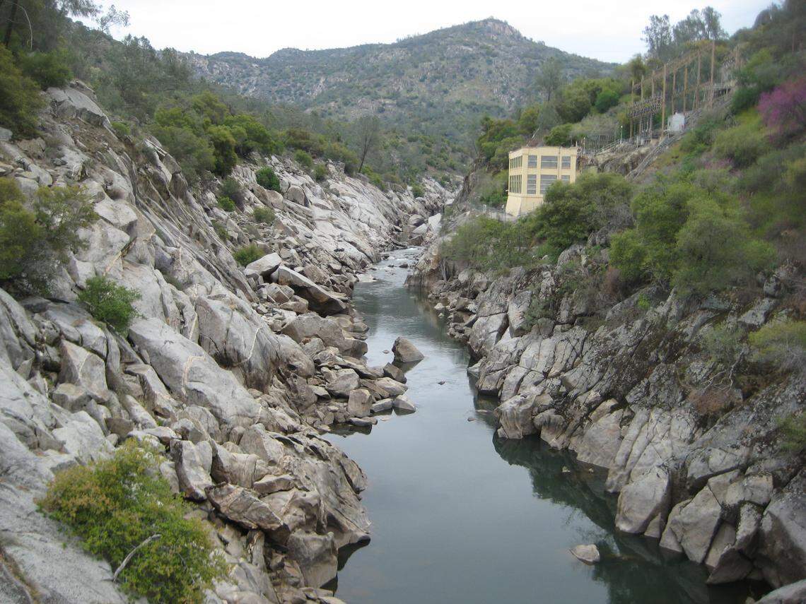 The PG&E Kerckhoff 1 Powerhouse sits above the San Joaquin River Gorge in this photograph looking upstream from the footbridge that spans the river at the special recreation management area near Auberry. The recently renamed San Joaquin Butte looms in the background.
