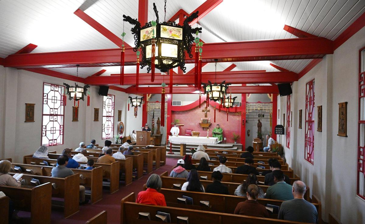 Chinese lanterns and red beams inside St. Genevieve Catholic Church reflect its Chinese history, photographed Sunday, Oct. 27, 2024, in Fresno.