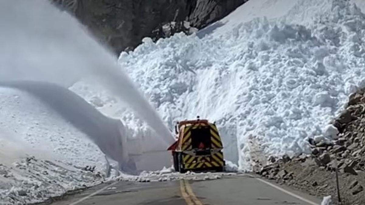 A Caltrans snowplow approaches a veritable wall of snow on Tioga Road, the road that crosses the Sierra Nevada range from Yosemite National Park to Lee Vining on HIghway 395 near Mono Lake on the east slope of the mountains, in this Caltrans photo from late April 2023. A stubborn record snowpack as well as road damage from winter storms is also creating problems in Kings Canyon and Sequoia National Parks and the Sierra and Sequoia National Forests.
