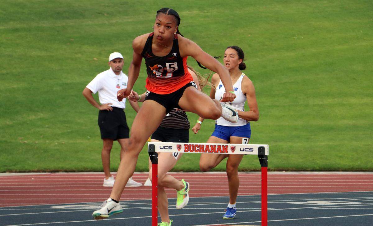 Central East junior Sofia Lopes clears a hurdle midway through the girls 300-meter hurdle race which she won in 41.88 seconds at the CIF Central Section Masters Track and Field Championships at Buchanan High’s Veterans Memorial Stadium on May 24, 2025.