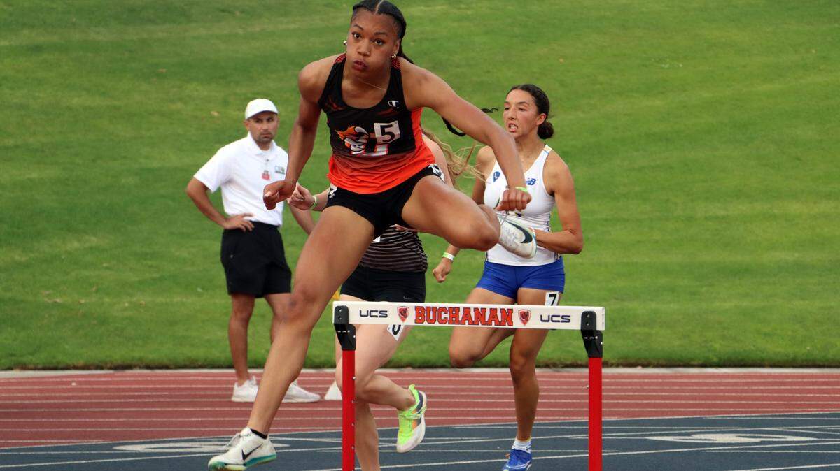 Central East junior Sofia Lopes clears a hurdle midway through the girls 300-meter hurdle race which she won in 41.88 seconds at the CIF Central Section Masters Track and Field Championships at Buchanan High’s Veterans Memorial Stadium on May 24, 2025.