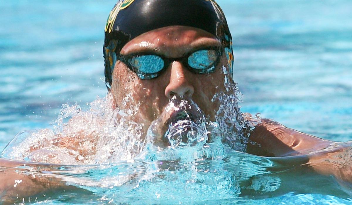 Kingsburg’s Lucas Huckabay swims to first place in heat 5 of the Boys 100 Yard Breastroke at the Clovis West Invitational Saturday, April 15, 2023 in Fresno. Clovis Unified’s Olympic Swim Complex at Clovis West opened this week after being closed almost a year for renovation and construction.