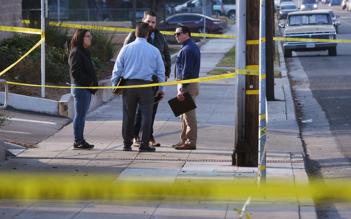 Investigators seen at the Princeton Square strip mall, scene of a double homicide at Blackstone and Princeton avenues Wednesday, Dec. 14, 2022 in Fresno.