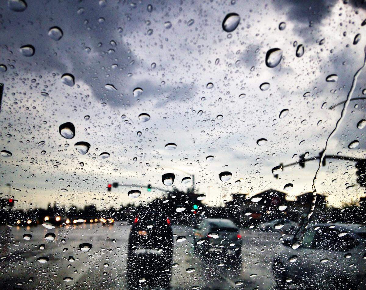 Raindrops hit a windshield at an intersection in Clovis where dark clouds opened up with a downpour late Sunday afternoon, Sept. 28, 2014. After a long, dry summer, a couple of rain spells in the morning and evening where a welcome site in the Central San Joaquin Valley.