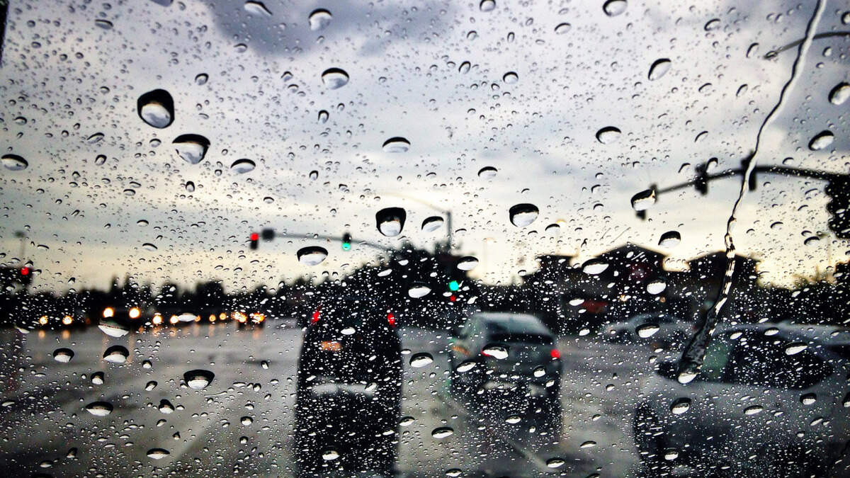 Raindrops hit a windshield at an intersection in Clovis where dark clouds opened up with a downpour on Sept. 28, 2014. An atmospheric river will bring rain to the Fresno area in November 2024.