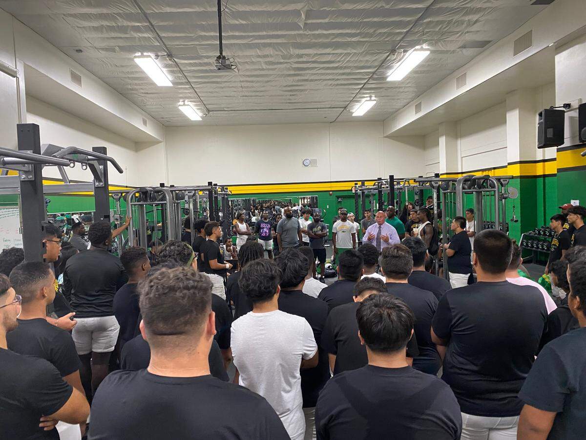 The Roosevelt High football listens to Fresno Major Jerry Dyer in the weight room on Monday, Aug. 22, 2022.