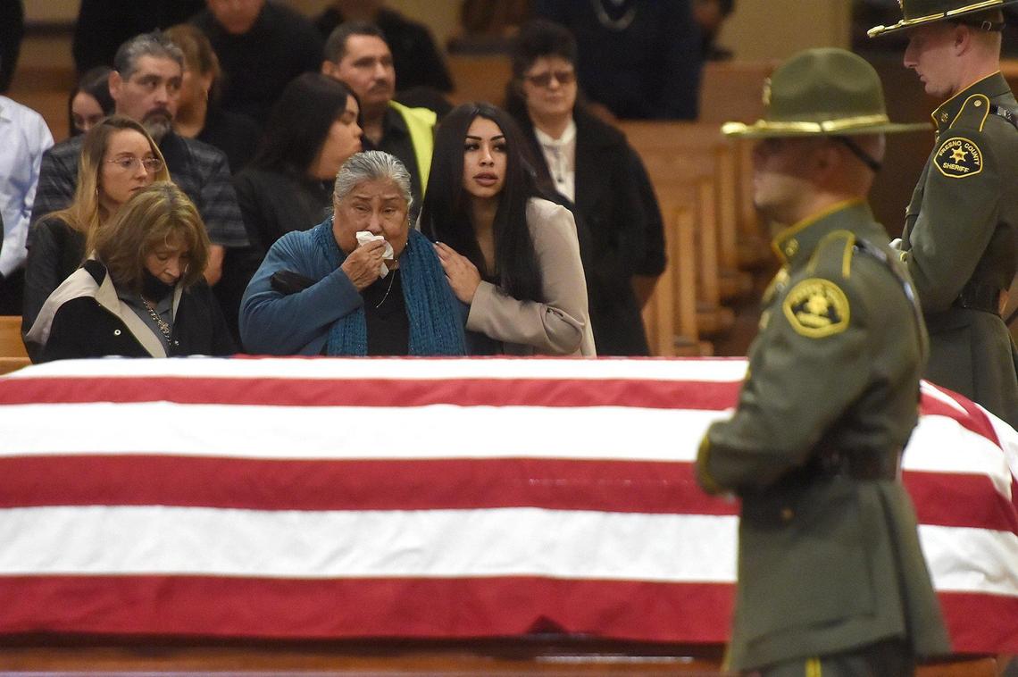 Family members of Fresno County Sheriff Correctional Officer Juan Cruz look on during his funeral service at Holy Spirit Catholic Church, Nov. 15, 2021. Cruz died of complications from Covid-19.