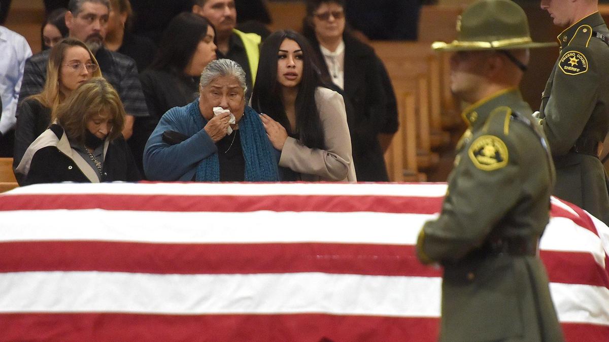 Family members of Fresno County Sheriff Correctional Officer Juan Cruz look on during his funeral service at Holy Spirit Catholic Church, Nov. 15, 2021. Cruz died of complications from Covid-19.
