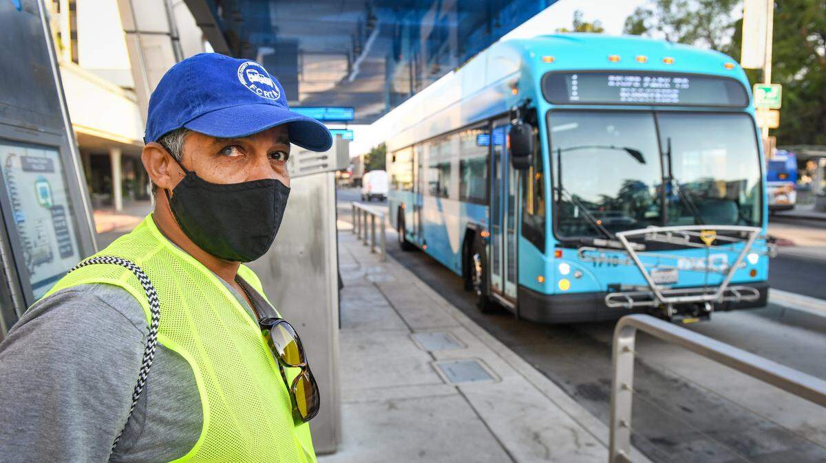 Yonas Paulos, of Fresno, who is visually impaired and relies on buses to get to his medical appointments, waits to catch a Fresno Area Express bus in downtown Fresno on Friday, Aug. 28, 2020.