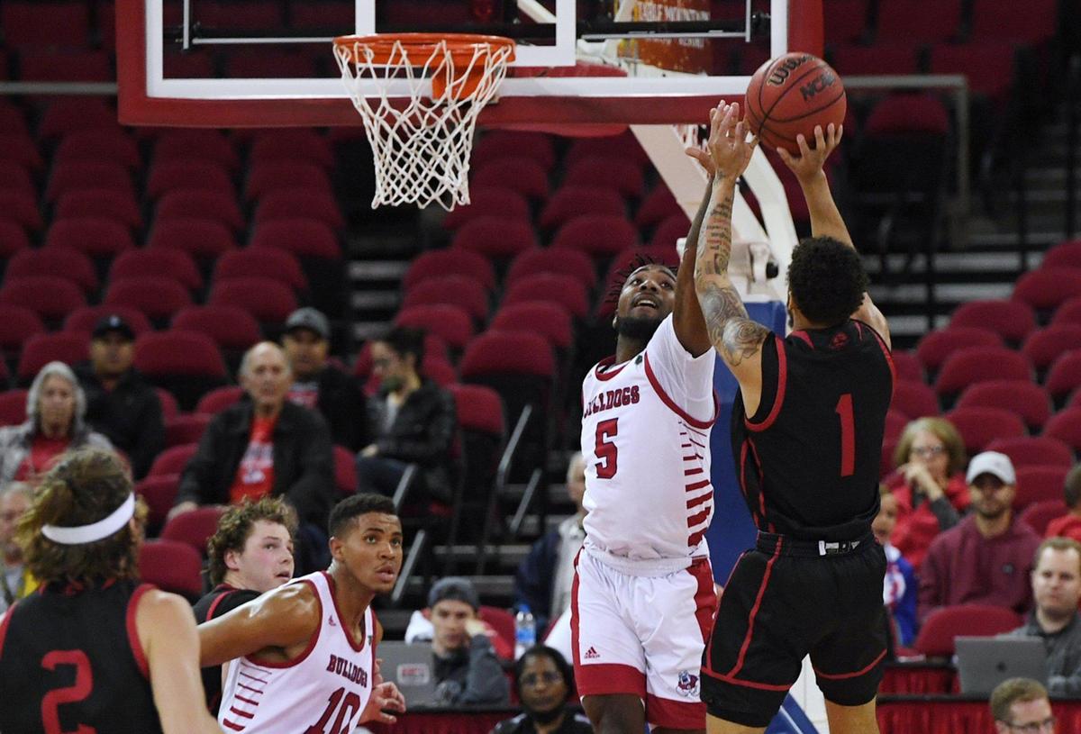 Fresno State’s Jordan Campbell, center, blocks Southern Utah’s Nick Fleming’s shot in the semifinal of The Basketball Classic Monday evening, March 28, 2022 in Fresno. The Bulldogs led 34-16 at halftime.