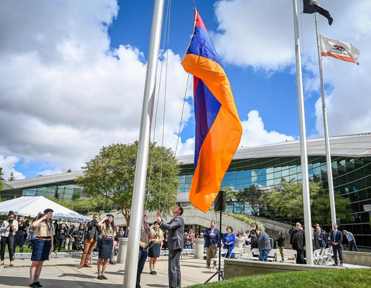 Congressman David Valadao, center, helps members of the Homenetmen Fresno Sassoon Chapter scouts raise the Armenian flag over Fresno City Hall during the annual Armenian genocide commemoration and flag raising ceremony on Friday, April 22, 2022.