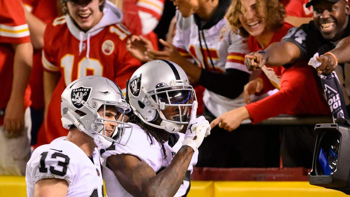 Las Vegas Raiders wide receiver Davante Adams celebrates his touchdown against the Kansas City Chiefs with wide receiver Hunter Renfrow and fans during the second half of an NFL game, Monday, Oct. 10, 2022 in Kansas City, Mo.