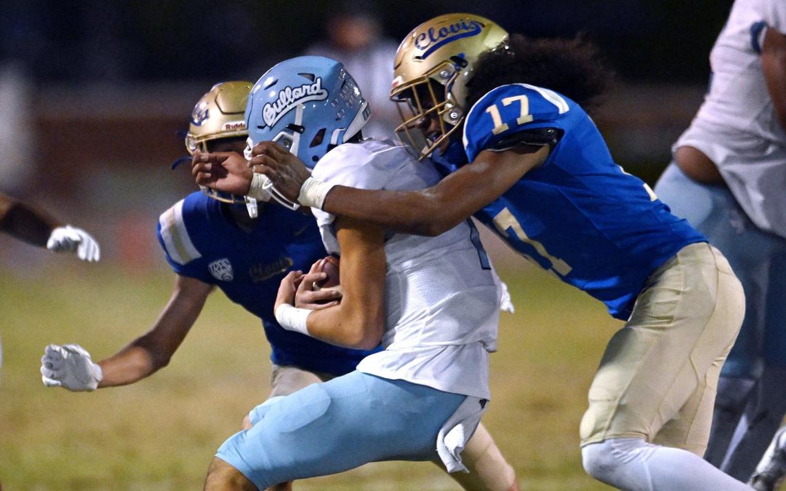 Bullard quarterback Tyler Franklin, center, is sacked by Clovis Friday night, Sept. 20, 2024 at Lamonica Stadium in Clovis.