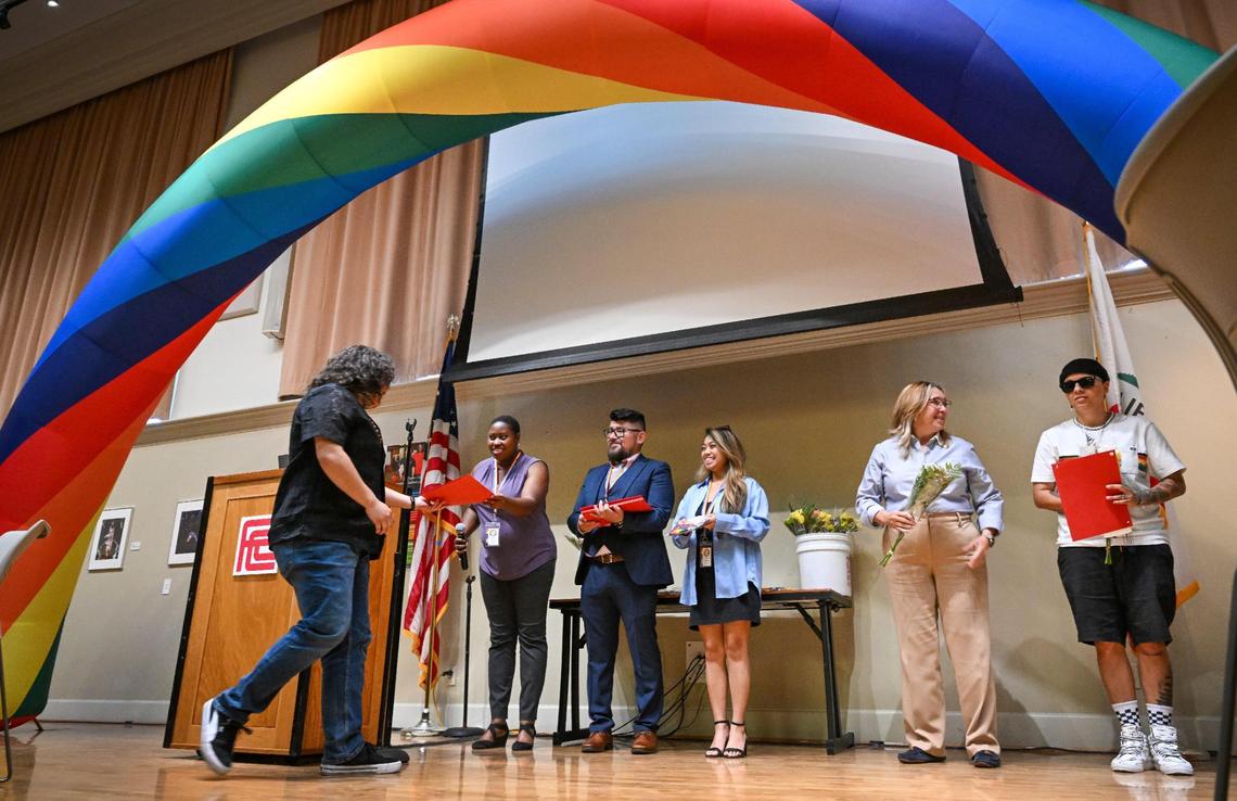 Graduates walk up to accept their certificates during the Rainbow Alliance Staff & Faculty Association Rainbow Graduation Celebration at Fresno City College on Wednesday, May 7, 2025.