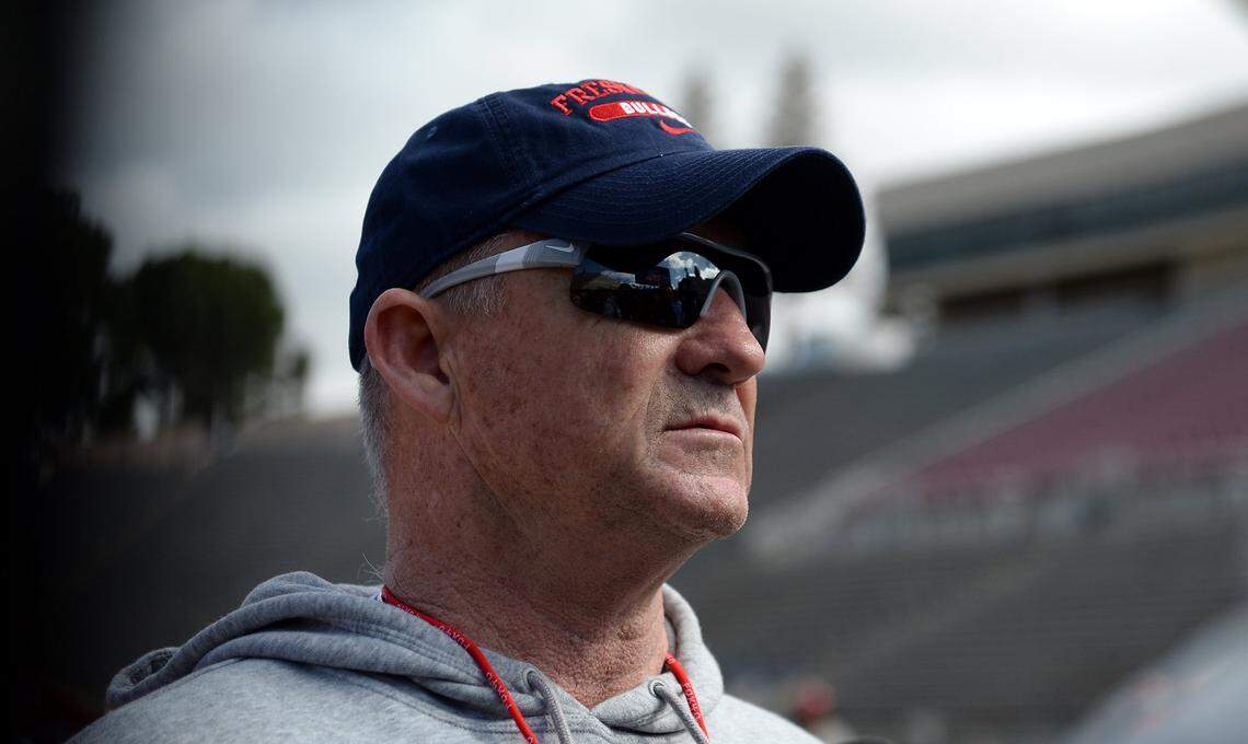 Bulldogs head football coach Jeff Tedford meets with the media on the field at the end of the first day of Fresno State spring football practice at Bulldog Stadium on Monday, March 27, 2017, in Fresno.