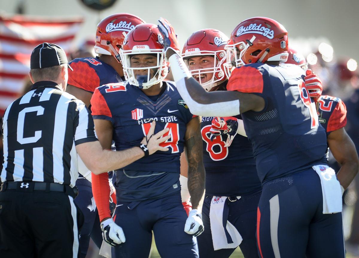 Fresno State defensive players congratulate their teammate Jaron Bryant after making a third down stop against Arizona State during their game at the Mitsubishi Las Vegas Bowl at Sam Boyd Stadium in Las Vegas on Saturday, Dec. 15, 2018.