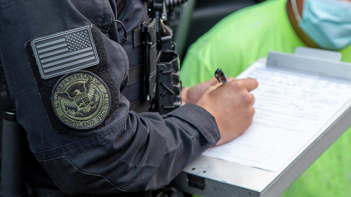 An officer with the Department of Homeland Security and U.S. Immigration and Customs Enforcement processes an arrest on an undocumented immigrant in California in this undated photo from ICE.