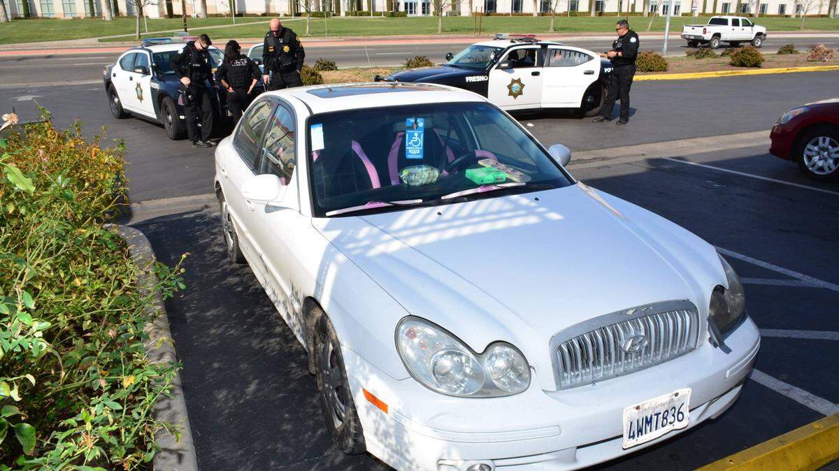 The car of four suspects who were arrested outside of University Inn on Shaw Avenue, across from Fresno State, on Tuesday. Police say the disabled placard was from the driver's deceased friend.