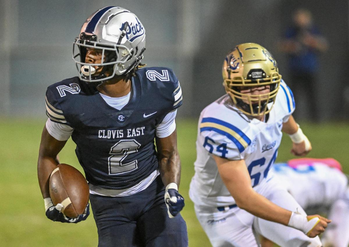 Clovis East’s Harold Duvall gets by Clovis’ Aiden Rosado before running down the sideline for a Wolf Pack touchdown during their game at Lamonica Stadium on Friday, Oct. 20, 2023.