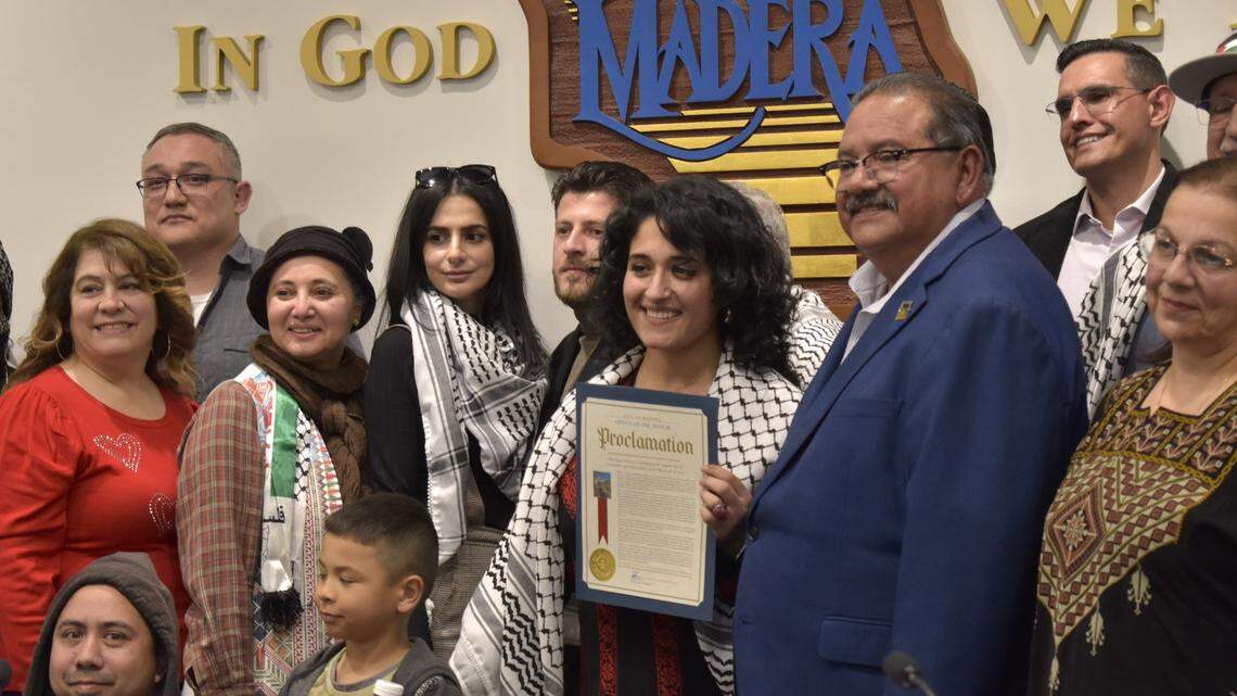 Madera Mayor Santos Garcia and other members of the City Council pose with members of the local Palestinian community after a council vote that passed a Gaza ceasefire resolution Wednesday, Feb. 14.