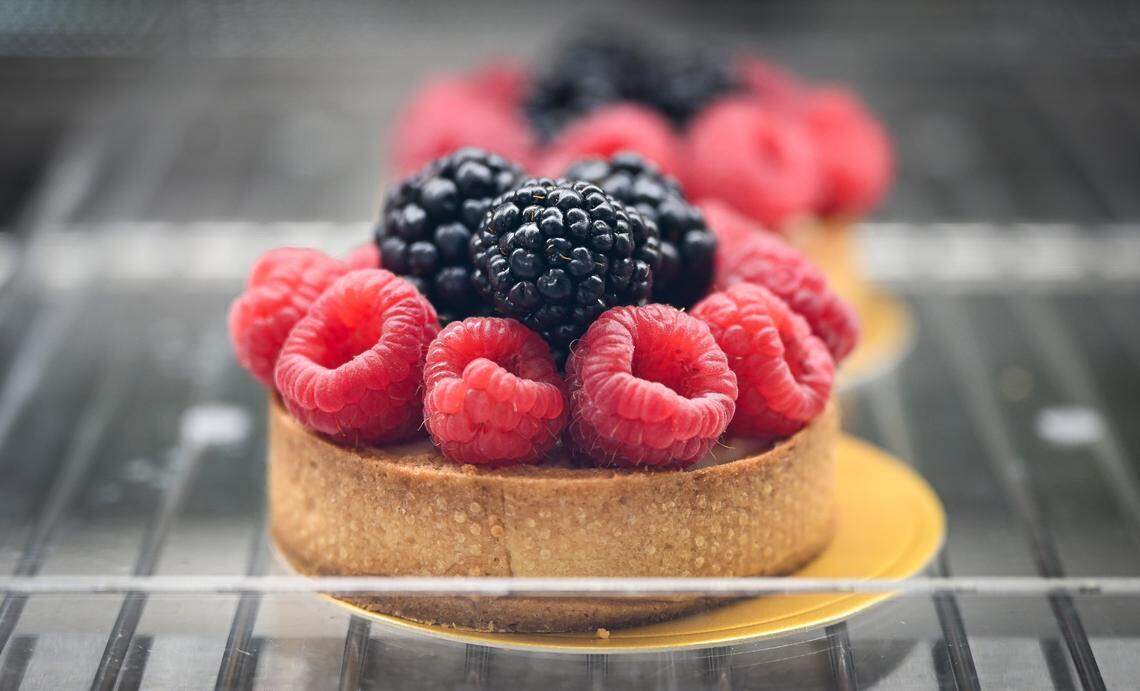 A fruit tart is displayed with various treats and baked goods in the cabinet Lodei Bakery & Cafe, an Armenian family-owned bakery on the northeast corner of Palm and Bullard.