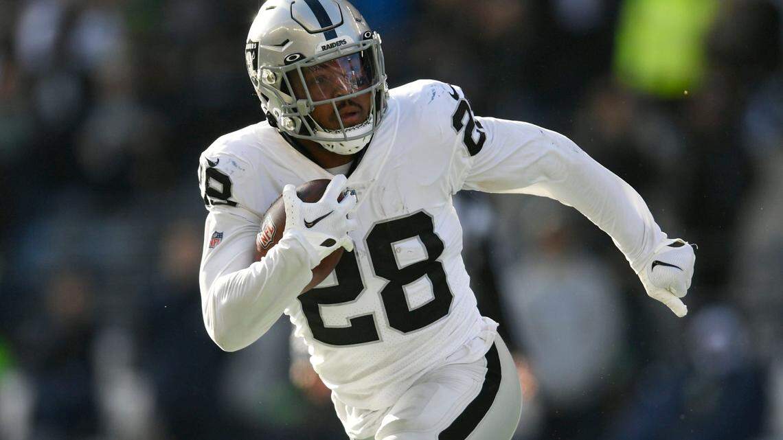 Las Vegas Raiders running back Josh Jacobs carries against the Seattle Seahawks during the first half of an NFL game Sunday, Nov. 27, 2022, in Seattle.