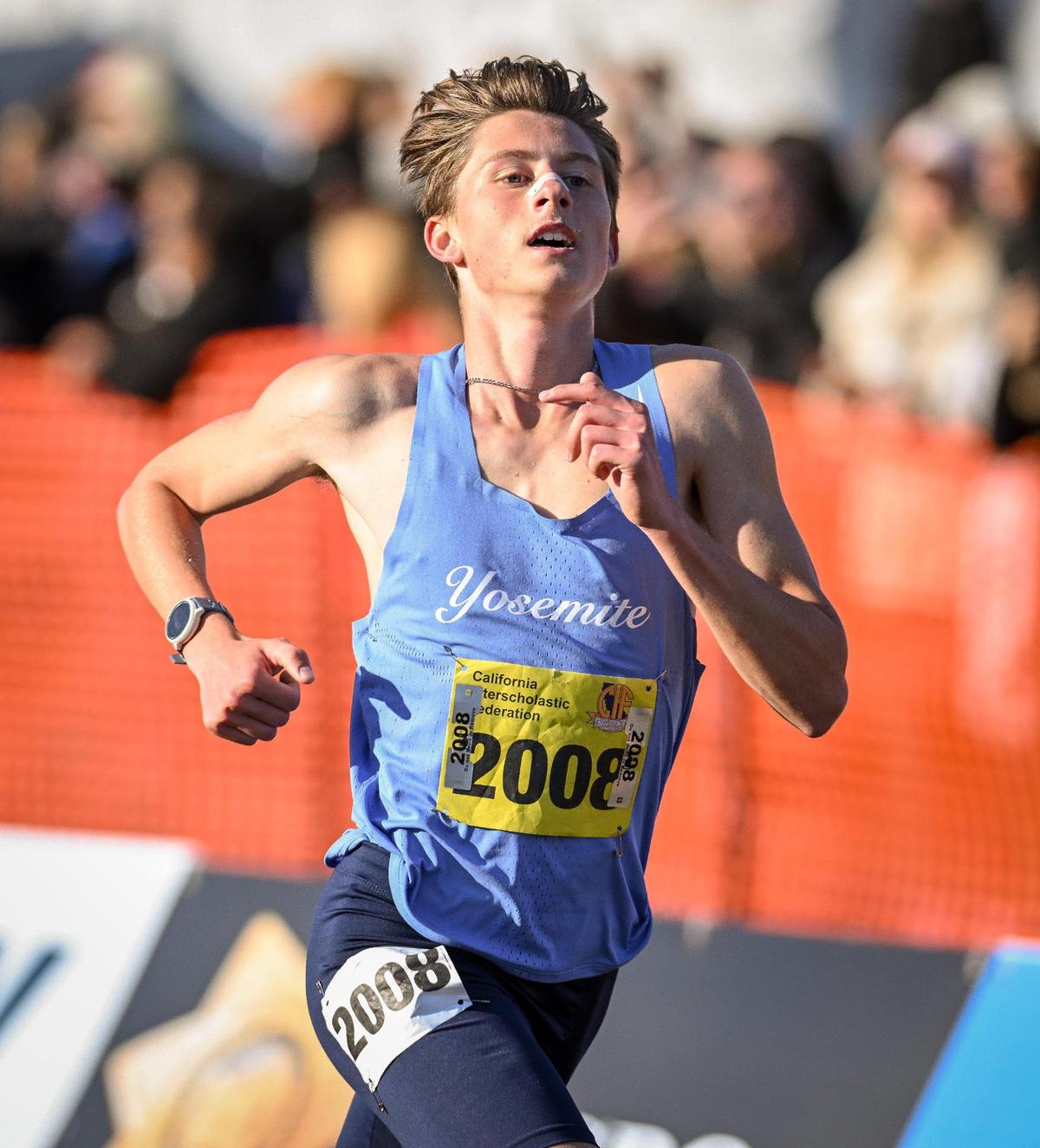Yosemite High’s Noah Graffigna reaches the finish line during the boys Division V state cross country championships at Woodward Park in Fresno on Saturday, Nov. 25, 2023.