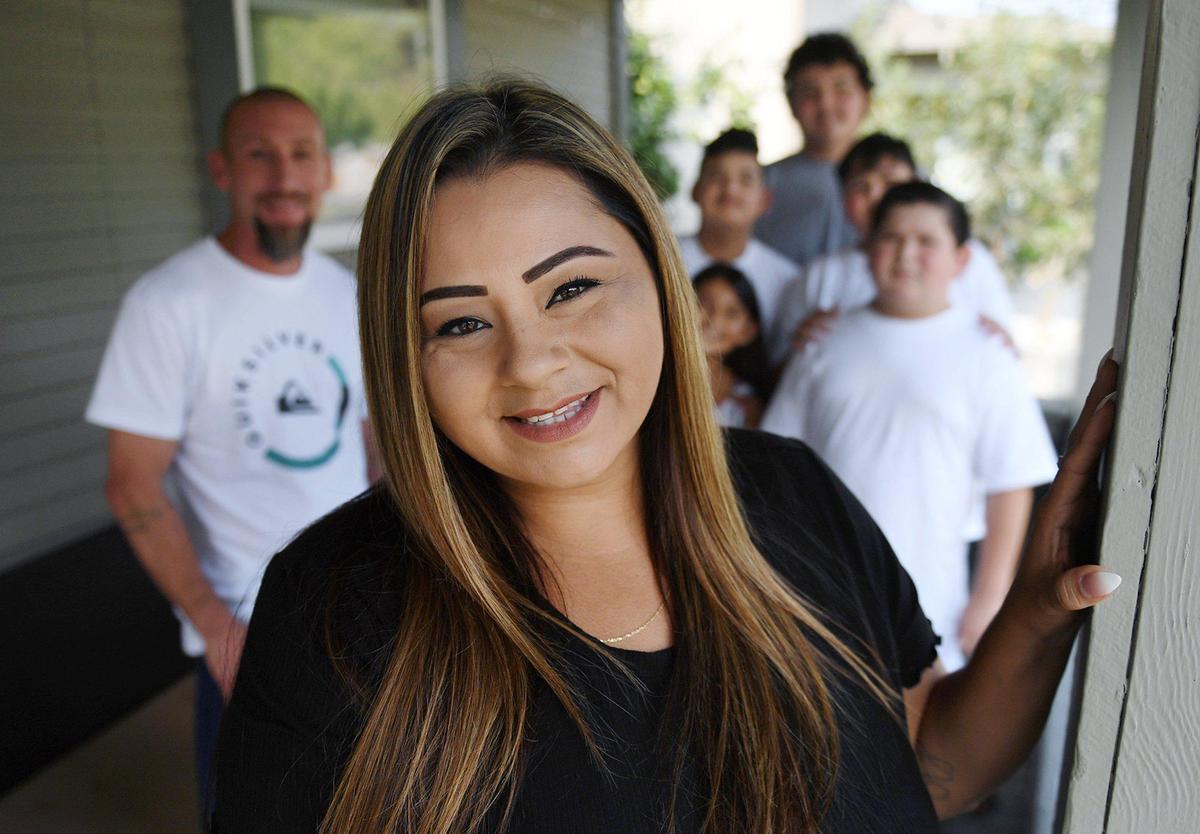Victoria Rocha, formerly incarcerated, center, pictured with her boyfriend Raul Reyes to the left and her children to the right, has helped establish a mentoring program at Fresno City College for others with her background called Rising Scholars. Photographed Wednesday, Oct. 7, 2020 in Fresno.