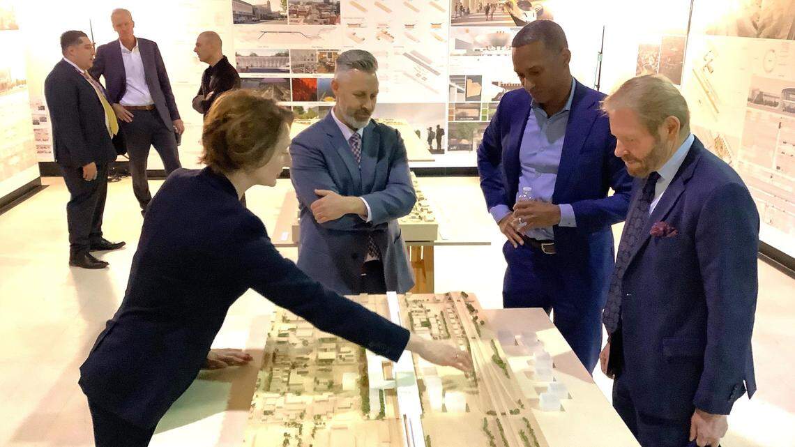 Margaret Cederoth, left, director of planning for the California High-Speed Rail Authority, describes features on a model of a future passenger station to the agency’s transportation planner Ben Lichty, second from left, and authority board members Anthony Williams and Tom Richards, far right, at the board’s Feb. 29, 2024, meeting in Sacramento.