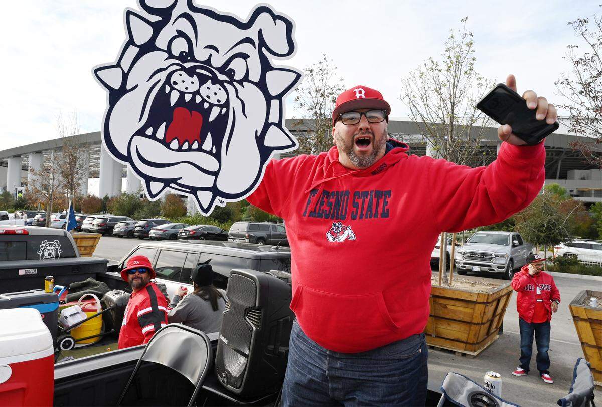 Paul Avila Jr. of Fresno tailgates in the SoFi Stadium parking lot as the Red Wave arrives for the Jimmy Kimmel LA Bowl against Washington State Saturday, Dec. 17, 2022 in Inglewood.