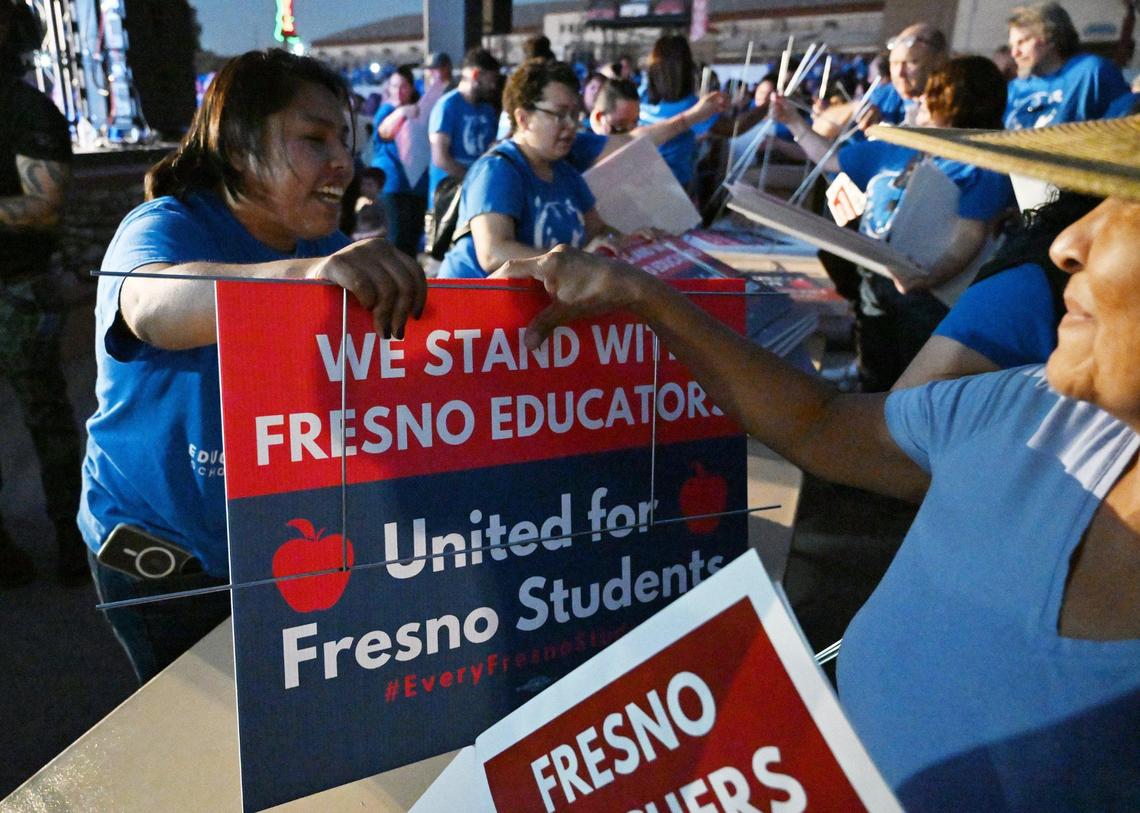 Yard signs are handed out after over 3,000 members of Fresno Teachers Association met to vote for strike authorization at the Paul Paul Theater Wednesday evening, Oct. 18, 2023 in Fresno.