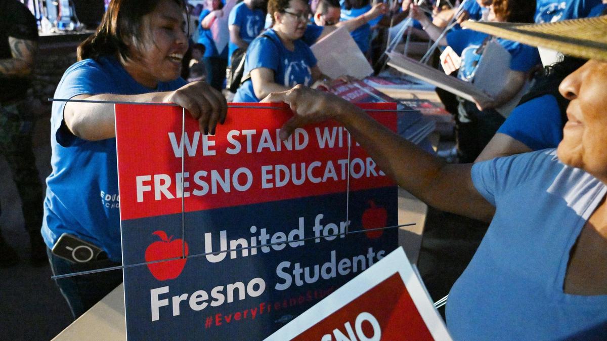 Yard signs are handed out after over 3,000 members of Fresno Teachers Association met to vote for strike authorization at the Paul Paul Theater Wednesday evening, Oct. 18, 2023 in Fresno.