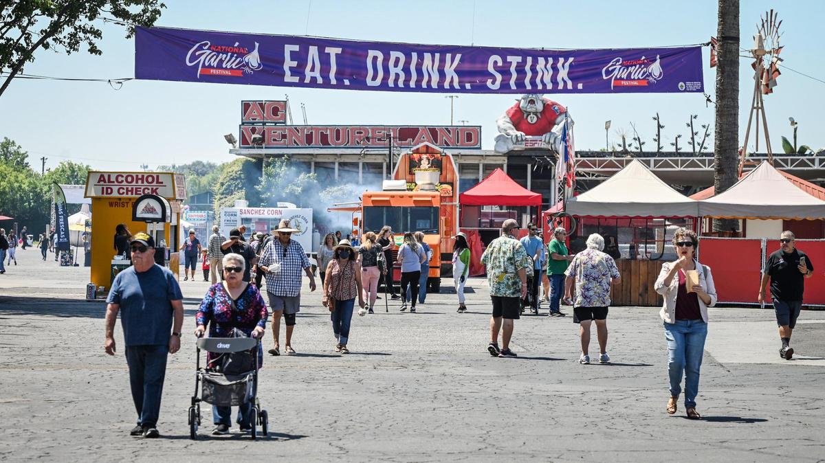 The first few visitors make their way onto the Fresno Fairgrounds on day one of the National Garlic Festival on Friday, May 13, 2022.