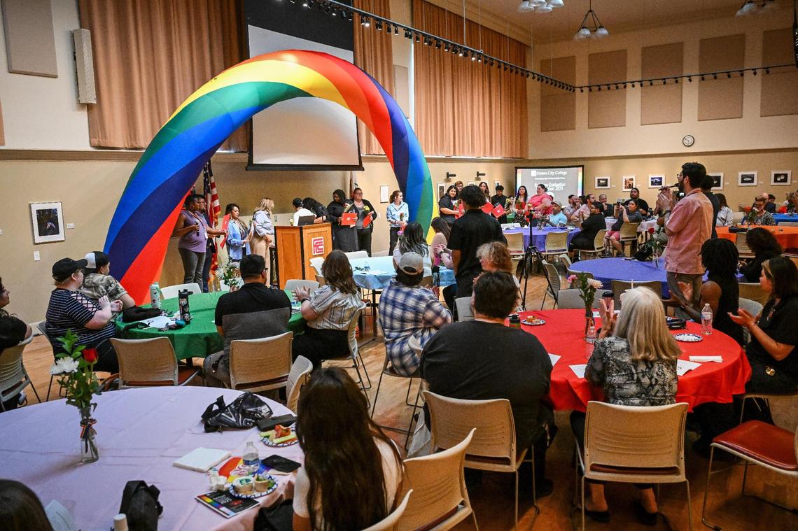 Graduates walk up to accept their certificates during the Rainbow Alliance Staff & Faculty Association Rainbow Graduation Celebration at Fresno City College on Wednesday, May 7, 2025.