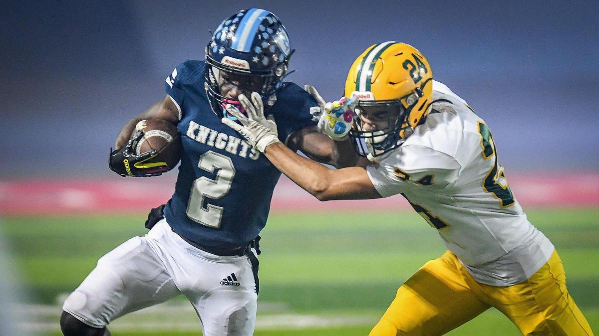 Bullard’s Jalyn Utendahl, left, gets pushed out of bounds by Kingsburg’s Caleb Irigoyen while taking the ball down the sideline during their Central Section Division II semifinal playoff game at McLane Stadium on Friday, Nov. 19, 2021.