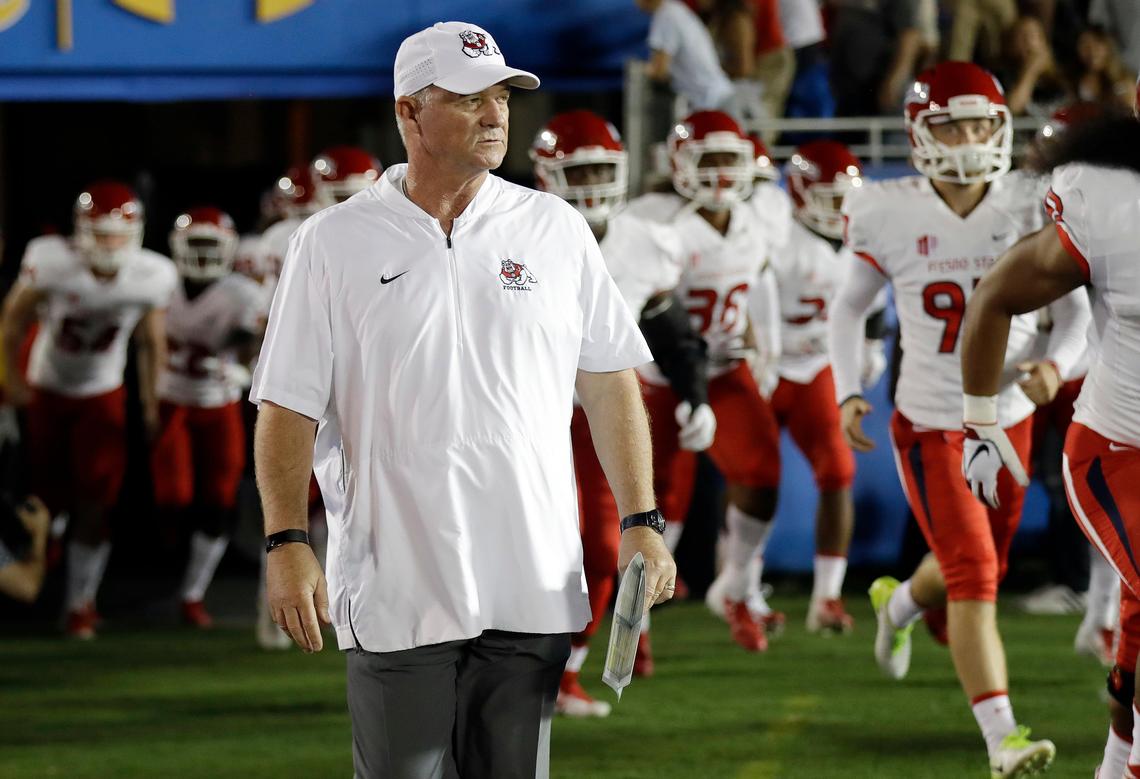 Fresno State coach Jeff Tedford leads his team onto the field at the Rose Bowl prior to the Bulldogs’ 38-14 victory over UCLA on Sept. 15, 2018.