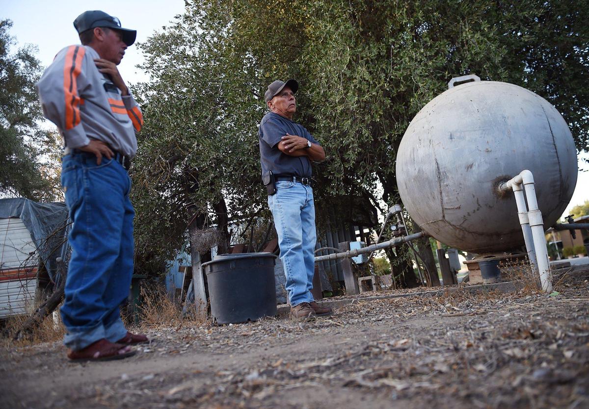 Amador Valenzuela, left, listens as Ricardo Valenzuela talks about water issues he’s had to contend with in the community of West Park, on Thursday, Oct. 3, 2019 west of Fresno.