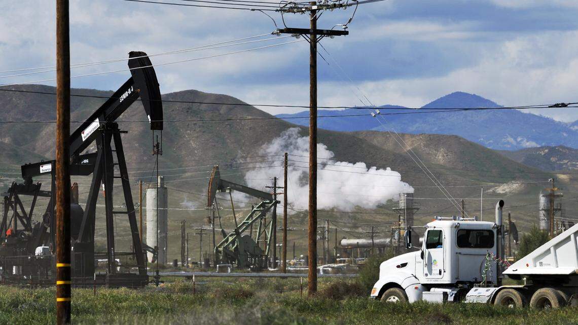 The land west of Coalinga is covered with working oil pumps.